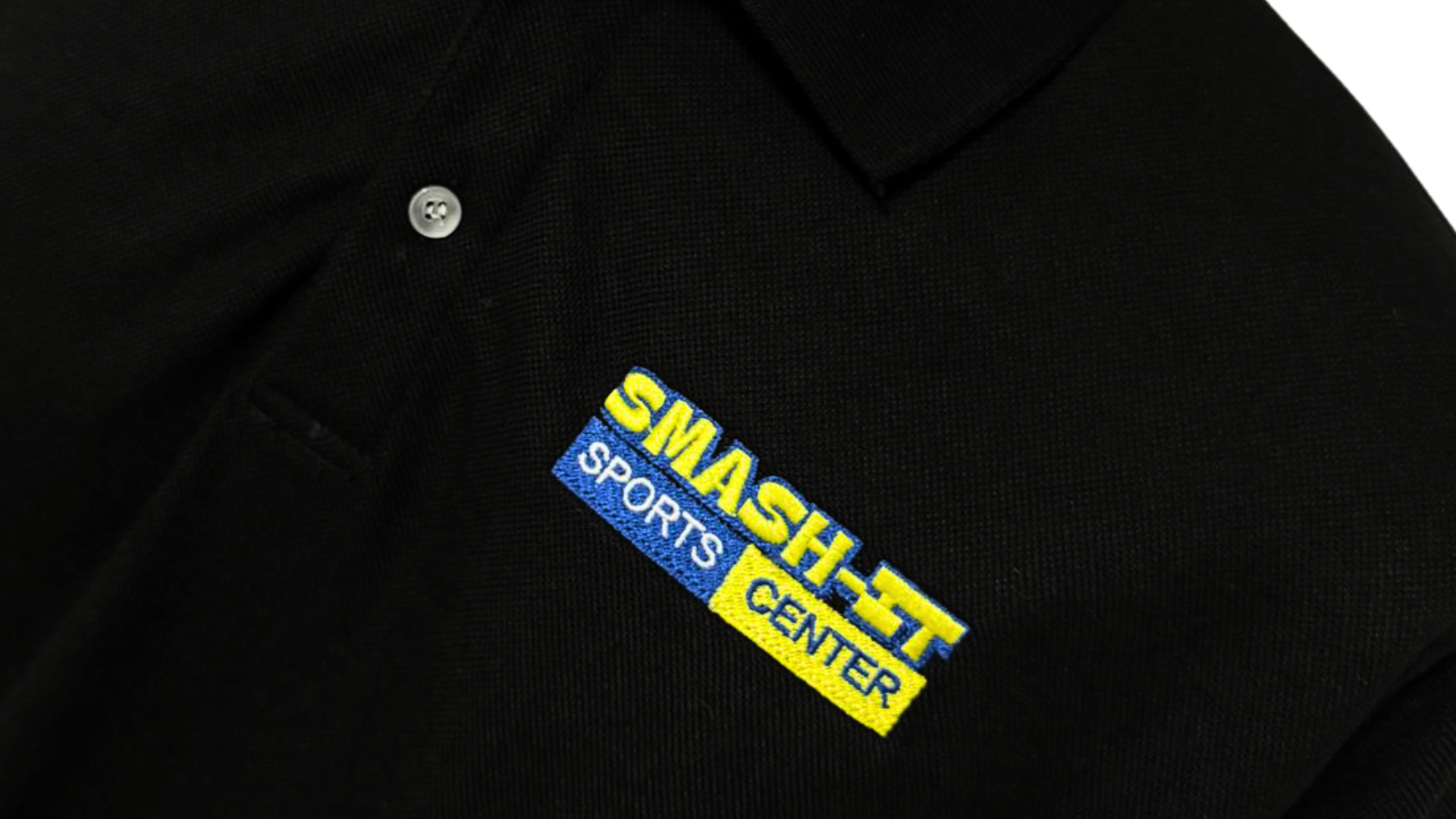 Embroidery machine stitching a company logo onto a polo shirt at the Ichiban Garments workshop